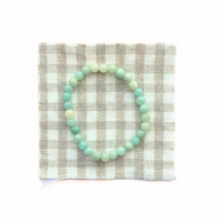 Thumbnail for Mint green beaded bracelet on a checkered fabric background