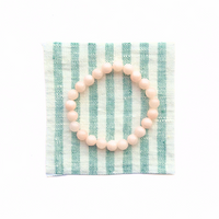 Thumbnail for Pink beaded bracelet on a striped green and white card