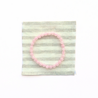 Thumbnail for Pink beaded bracelet on a striped fabric background